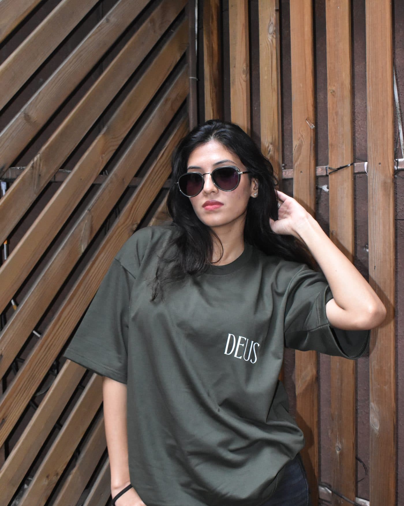 Model wearing the DEUS Glasses olive green oversized T-shirt, front, with DEUS chest logo