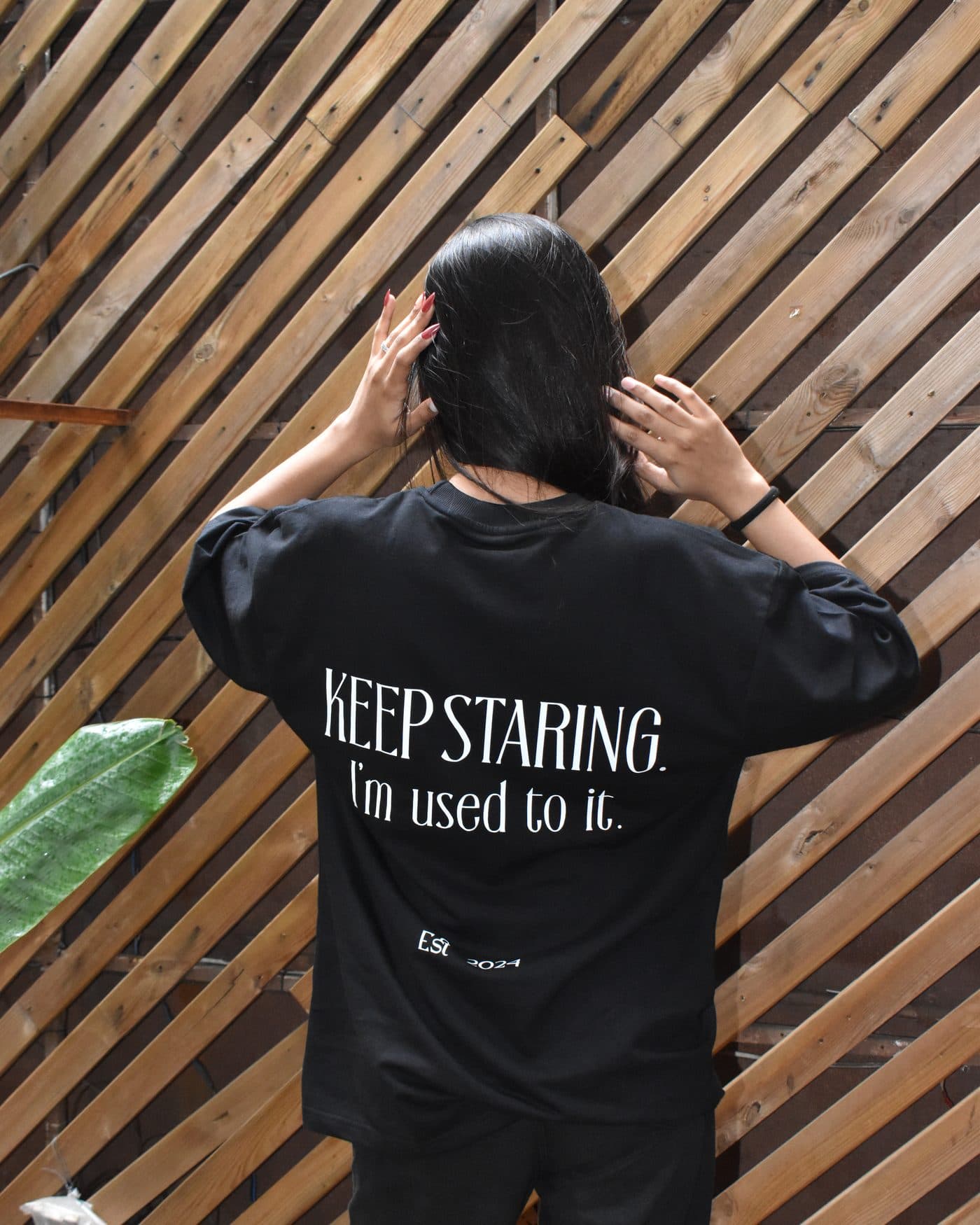 Back of the DEUS Keep Staring black oversized T-shirt showing the “KEEP STARING. I’m used to it.” print